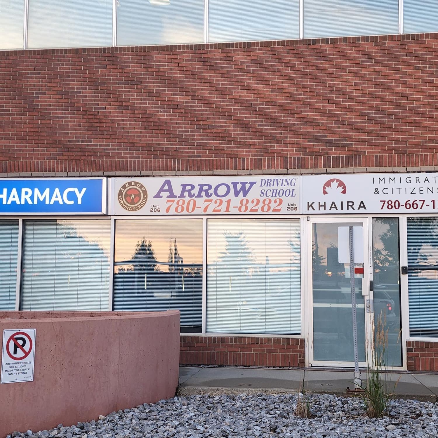 Arrow Driving School fascia panel on a brick building