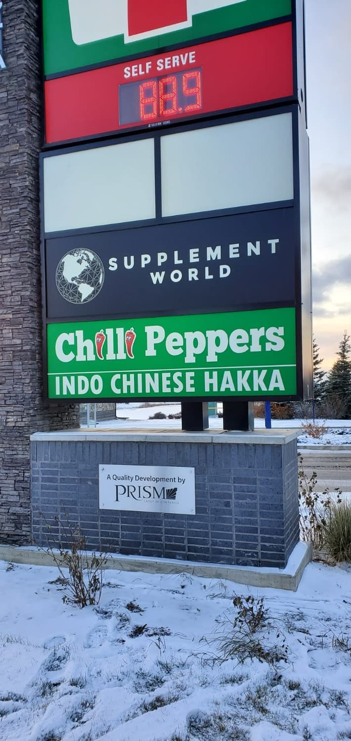 Multi-tenant pylon sign with Supplement World and Chilli Peppers panels