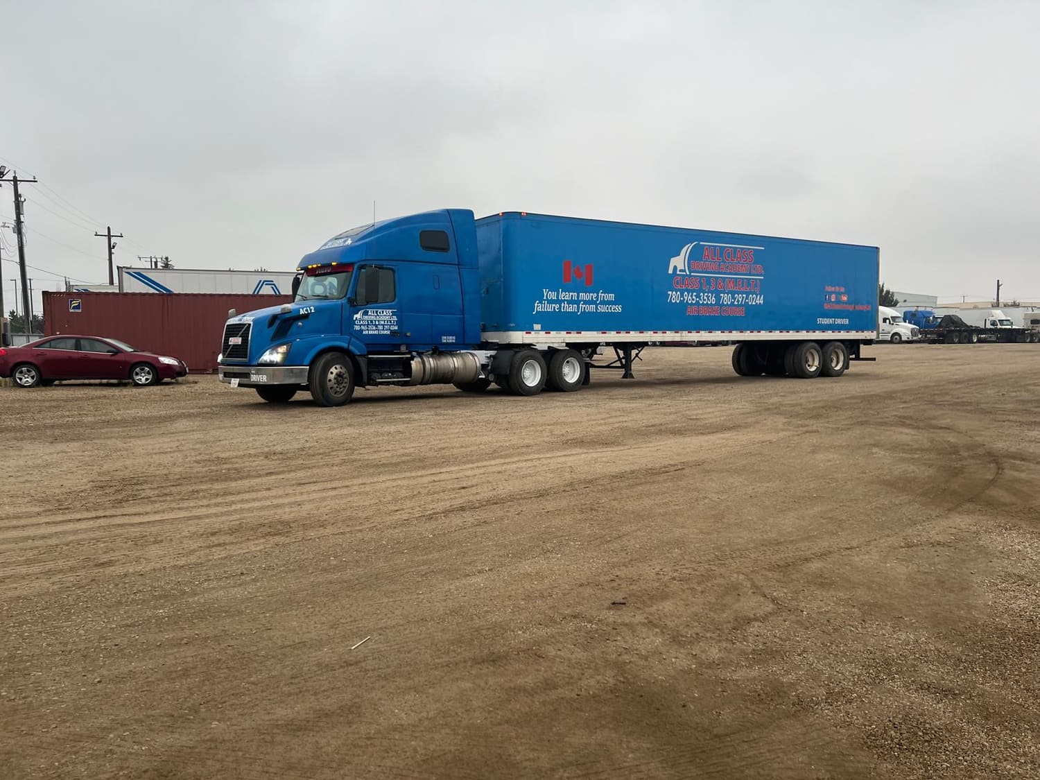 Highway tractor and trailer with fleet lettering in the yard