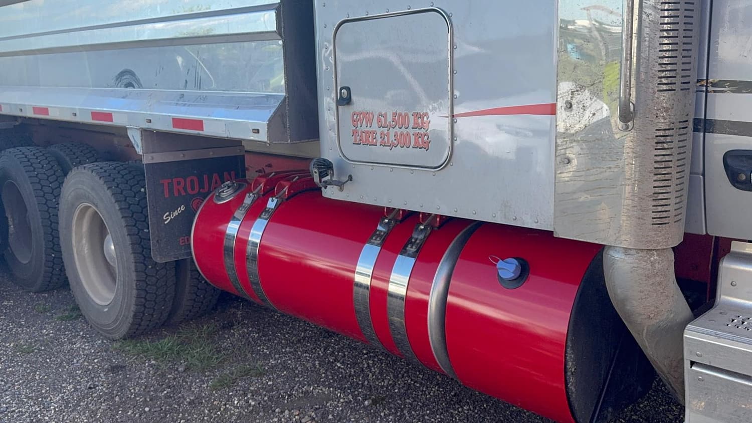 Red wrapped fuel tank on a highway tractor